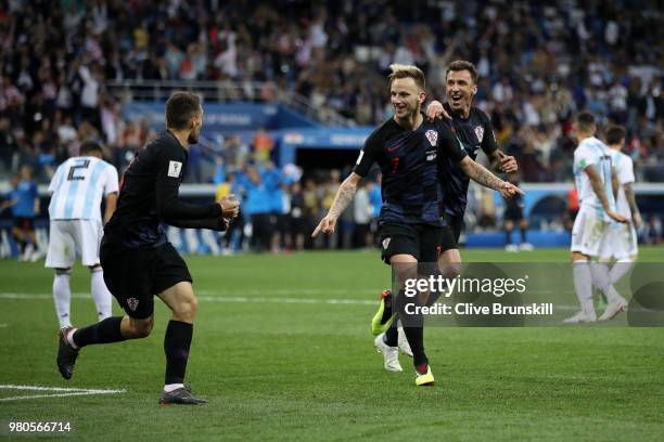 Ivan Rakitic of Croatia celebrates with teammates Mateo Kovacic and Mario Mandzukic of Croatia after scoring his team's third goal during the 2018...