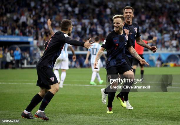 Ivan Rakitic of Croatia celebrates with teammates Mateo Kovacic and Mario Mandzukic of Croatia after scoring his team's third goal during the 2018...