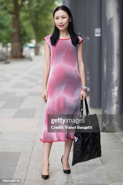 Guest poses wearing Issey Miyake after the Issey Miyake show at the Universite Pierre et Marie Curie during Paris Fashion Week Menswear SS19 on June...