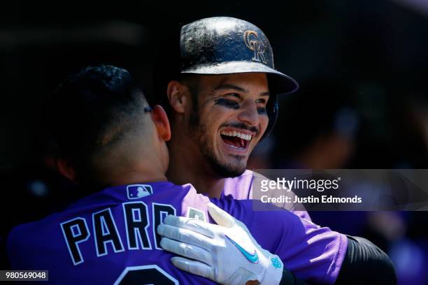Nolan Arenado of the Colorado Rockies celebrates his three-run home run with Gerardo Parra during the first inning against the New York Mets at Coors...
