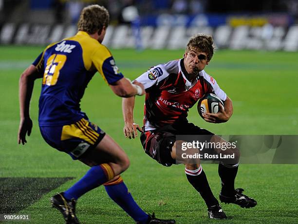 Kenny Lynn of the Highlanders tackles Michael Killian of the Lions during the round seven Super 14 between the Highlanders and the Lions at...