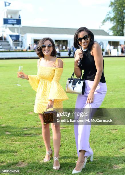 Georgia May Foote and Amal Fashanu step in the divots at the Laureus Polo Cup the at Ham Polo Club on June 21, 2018 in Richmond, England.