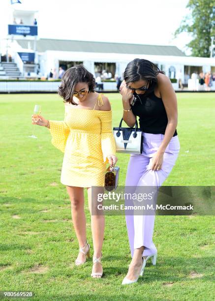 Georgia May Foote and Amal Fashanu step in the divots at the Laureus Polo Cup the at Ham Polo Club on June 21, 2018 in Richmond, England.