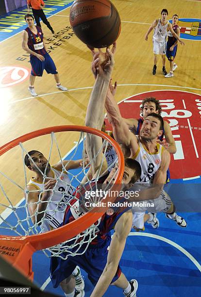 Fran Vazquez, #17 of Regal FC Barcelona competes with Marko Jaric, #8 of Real Madrid during the Euroleague Basketball 2009-2010 Play Off Game 2...