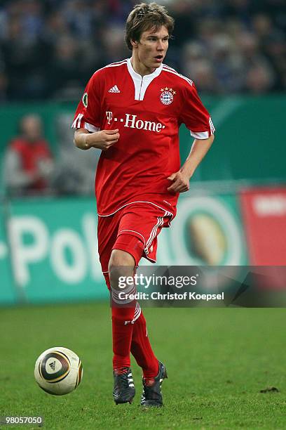 Holger Badstuber of Bayern runs with the ball during the DFB Cup semi final match between FC Schalke 04 and FC Bayern Muenchen at Veltins Arena on...
