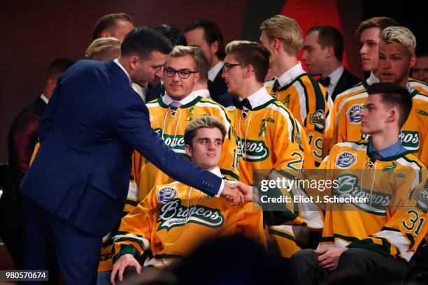 Patrice Bergeron of the Boston Bruins shakes the hand of Jacob Wassermann of the Humboldt Broncos during the 2018 NHL Awards presented by Hulu at The...