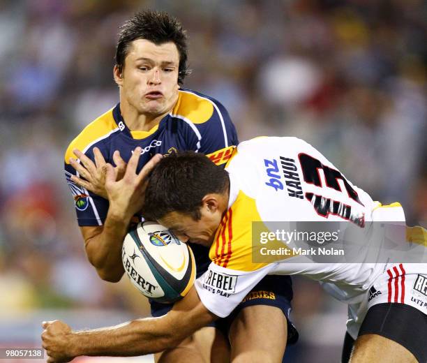 Adam Ashley-Cooper of the Brumbies is tackled by Richard Kahui of the Chiefs during the round seven Super 14 match between the Brumbies and the...