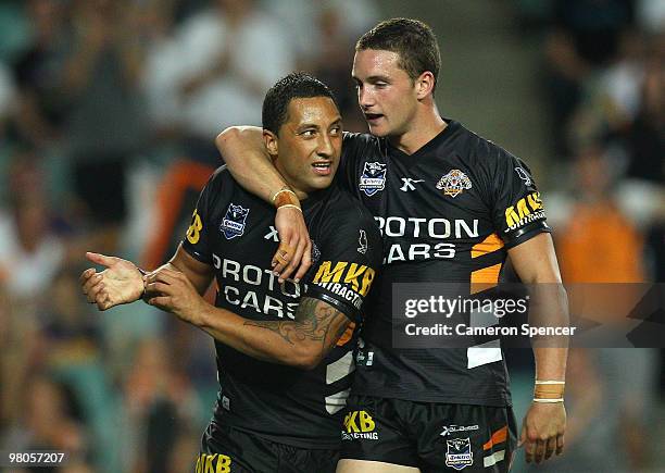 Benji Marshall of the Tigers is congratulated by team mate Tim Moltzen after scoring a try during the round three NRL match between the West Tigers...