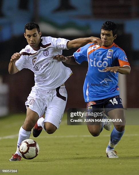 Argentina's Lanus midfielder Eduardo Ledesma vies for the ball with Bolivia's Blooming midfielder Jorge Andia during their Copa Libertadores 2010...