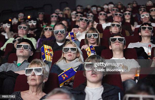 Customers wear 3D glasses to watch a film at the BFI IMAX cinema in London, U.K., on Thursday, March 25, 2010. "Alice in Wonderland," Tim Burton's...