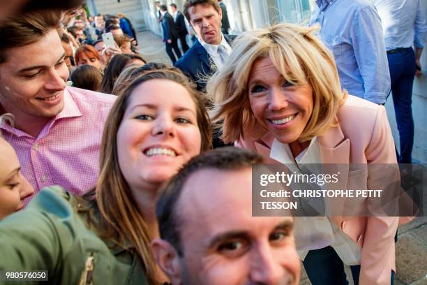 French president's wife Brigitte Macron poses for pictures during the annual "Fete de la Musique" in the courtyard of the Elysee Palace in Paris, on...