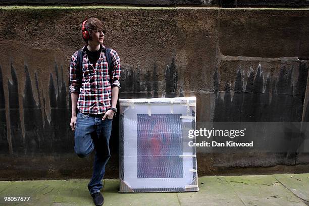 An artist arrives at The Royal Academy of Arts to hand in works completed for the 242nd Summer Exhibition on March 26, 2010 in London, England. The...