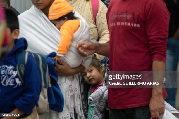 Migrants line up at El Chaparral port of entry in Tijuana, Mexico, in the boder with the United States on June 21, 2018. - US lawmakers were poised...