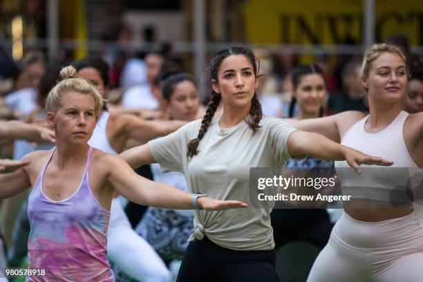 American gymnast and two-time Olympian Aly Raisman participates in a mass yoga class in ManhattanÕs Times Square to celebrate the summer solstice and...