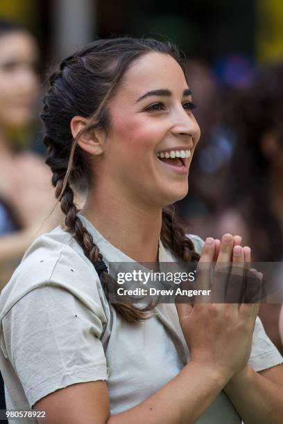 American gymnast and two-time Olympian Aly Raisman participates in a mass yoga class in ManhattanÕs Times Square to celebrate the summer solstice and...