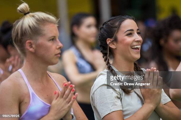 American gymnast and two-time Olympian Aly Raisman participates in a mass yoga class in ManhattanÕs Times Square to celebrate the summer solstice and...