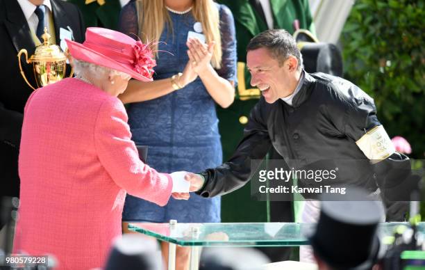 Queen Elizabeth II presents Frankie Dettori with his prize after he rode Stradivarius to win The Gold Cup on day 3 at Ascot Racecourse on June 21,...