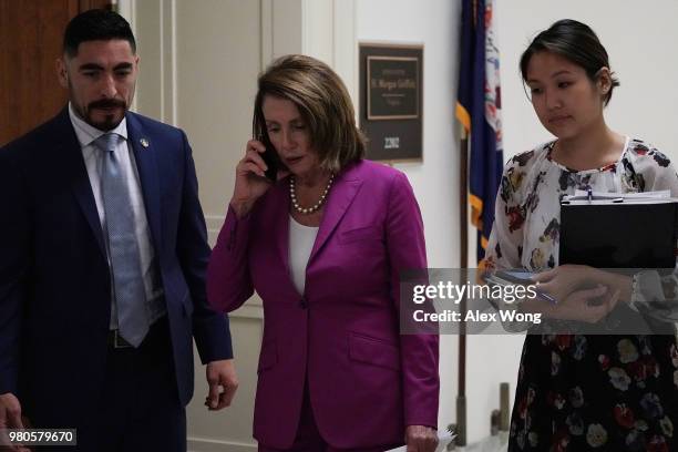 House Minority Leader Rep. Nancy Pelosi talks on the phone as she arrives at a "shadow hearing" before the Democratic Women's Working Group June 21,...