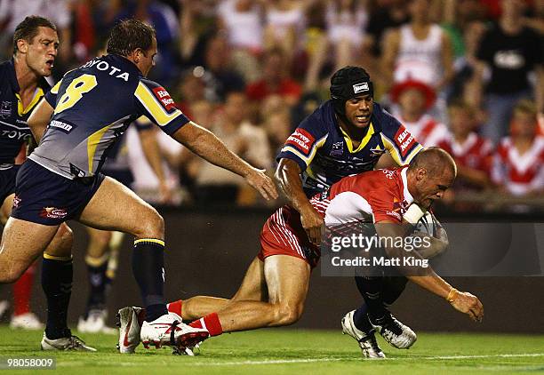 Matt Cooper of the Dragons dives over to score a try during the round three NRL match between the St George Dragons and the North Queensland Cowboys...