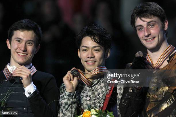 Daisuke Takahashi of Japan pose with his gold medal as Patrick Chan of Canada and Brian Joubert of France look on after the Men's Free Skate during...