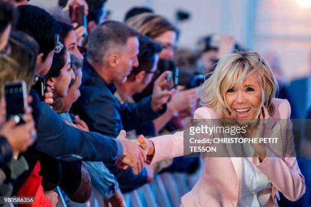 French president's wife Brigitte Macron greets people during the annual "Fete de la Musique" in the courtyard of the Elysee Palace, in Paris, on June...