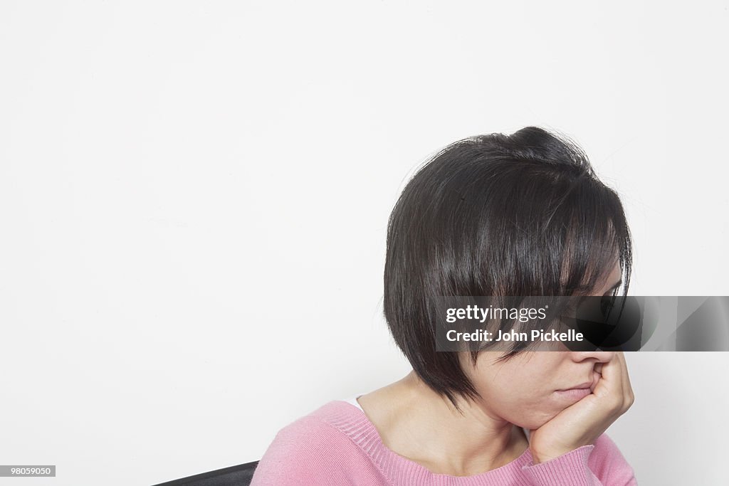 Woman sitting on a chair thinking