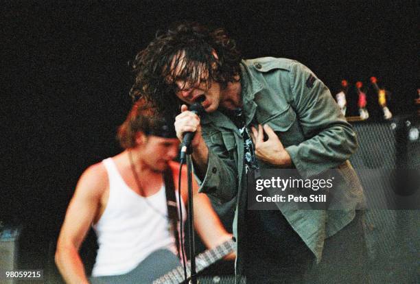 Jeff Ament and Eddie Vedder of Pearl Jam perform on stage in Finsbury Park on July 11th, 1993 in London, England.