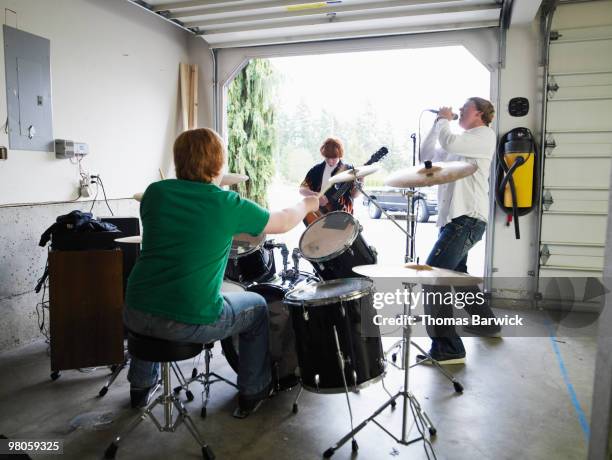 teen garage band playing rearview - percussion ensemble stock pictures, royalty-free photos & images