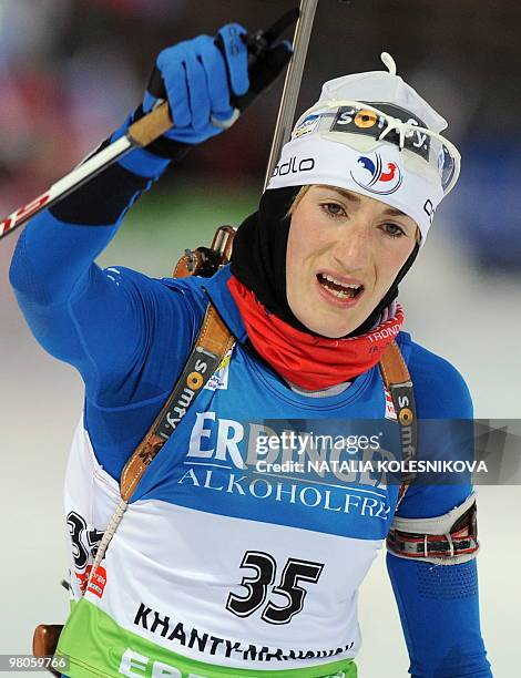 France's Marie-Laure Brunet celebrates as she crosses the finish line in second place during the women's 7,5 km sprint event of the Biathlon World...