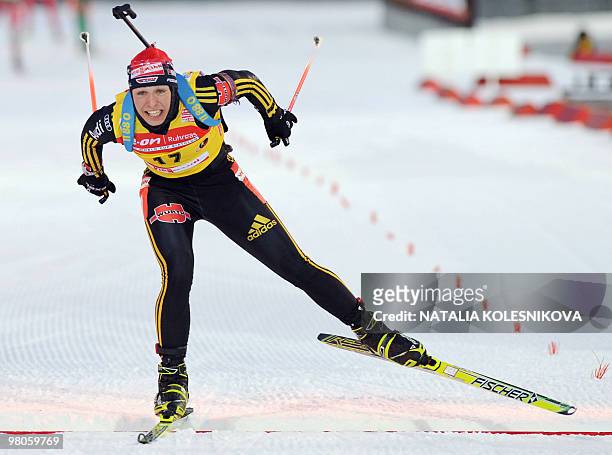 Germany's Magdalena Neuner crosses the finish line to place 8th of the women's 7,5 km sprint event at the Biathlon World Cup in the Siberian city of...
