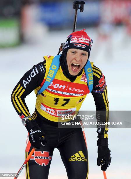 Germany's Magdalena Neuner reacts as she crosses the finish line during the women's 7,5 km sprint event of the Biathlon World Cup in the Siberian...