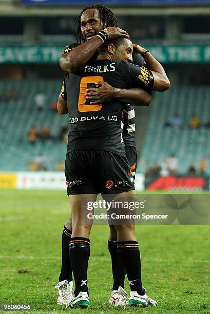 Benji Marshall of the Tigers is congratulated by team mate Lote Tuqiri after scoring a try during the round three NRL match between the West Tigers...