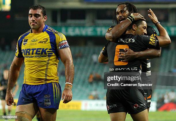 Benji Marshall of the Tigers is congratulated by team mate Lote Tuqiri after scoring a try during the round three NRL match between the West Tigers...