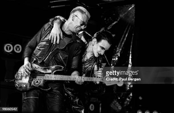 Adam Clayton and Bono of U2 perform on stage on the Zooropa Tour at Kuip on May 10th 1993 in Rotterdam, Netherlands. Adam Clayton plays a Fender...