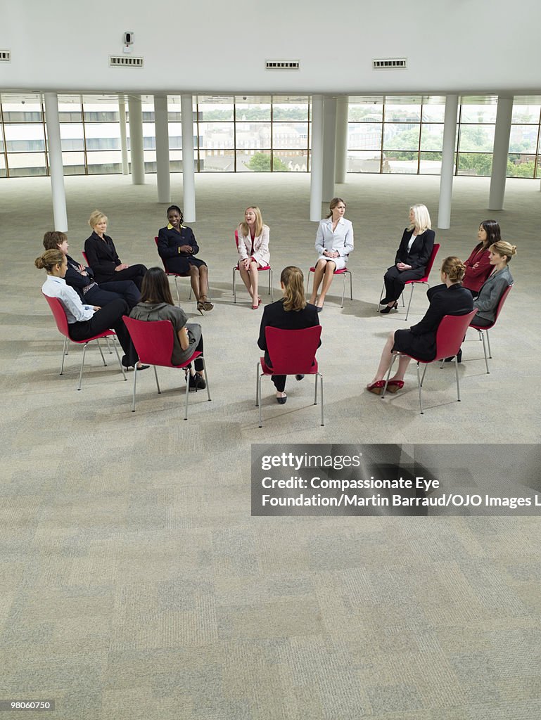 Business women sitting in a circle talking