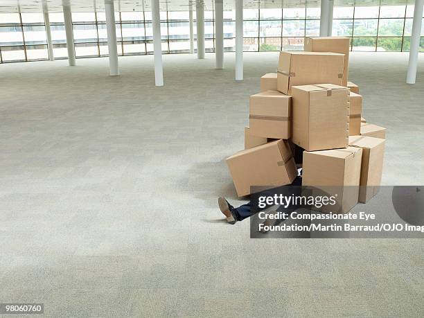 mans legs sticking out from a pile of boxes - top of cardboard box stock pictures, royalty-free photos & images