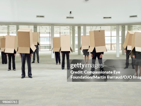 A group of people with boxes over their heads A group of people with boxes over their heads