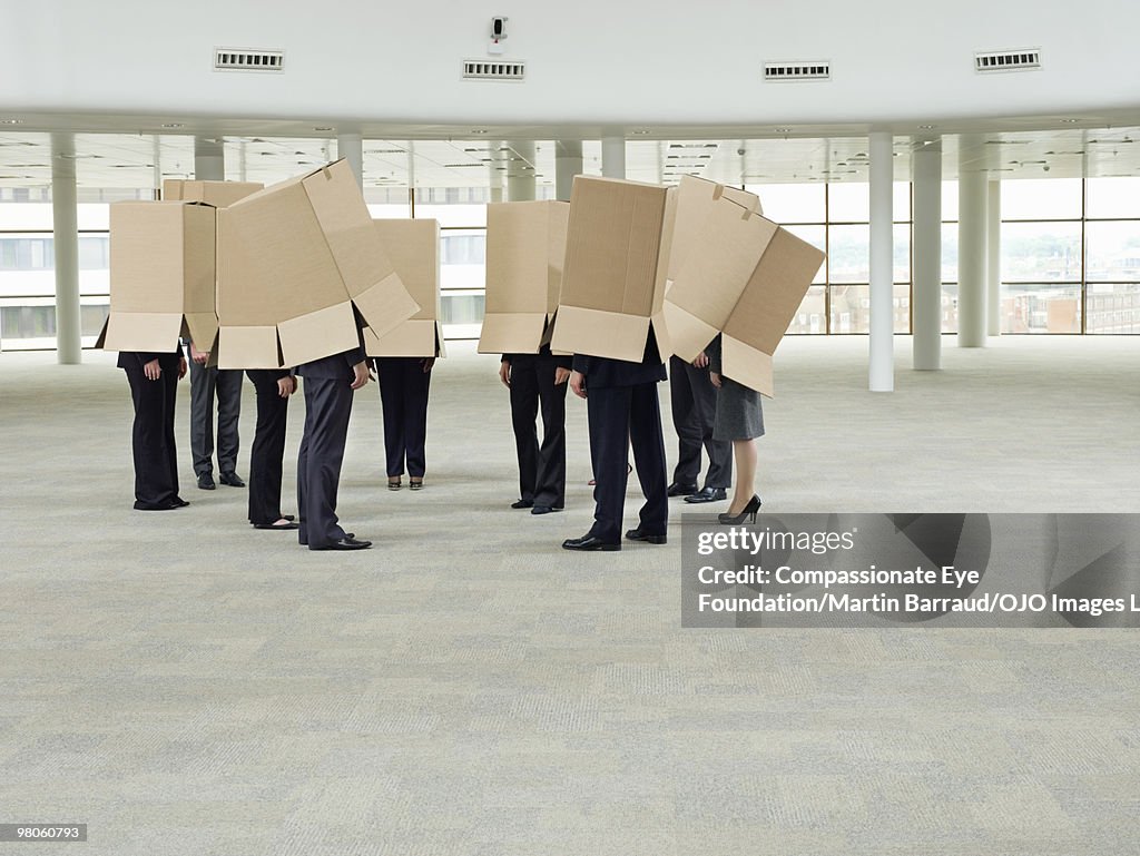 A group of people with boxes on their heads
