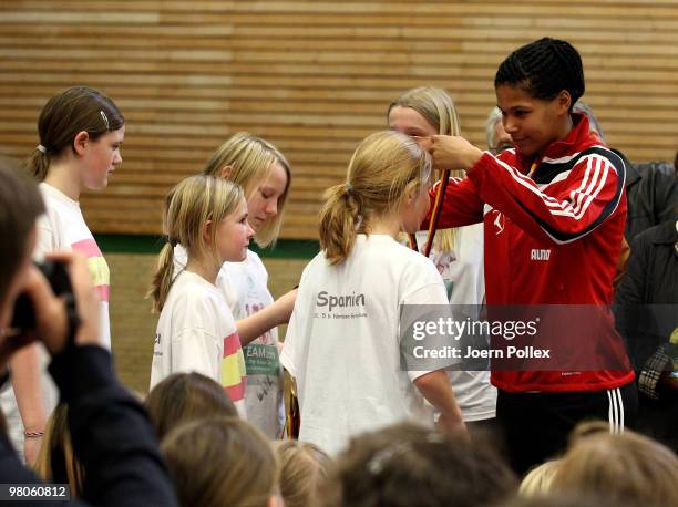 Navina Omilade of the DFB Women National Team honours the second winner during a school girls Football World Cup at the Mehrzweckhalle Buesum on...