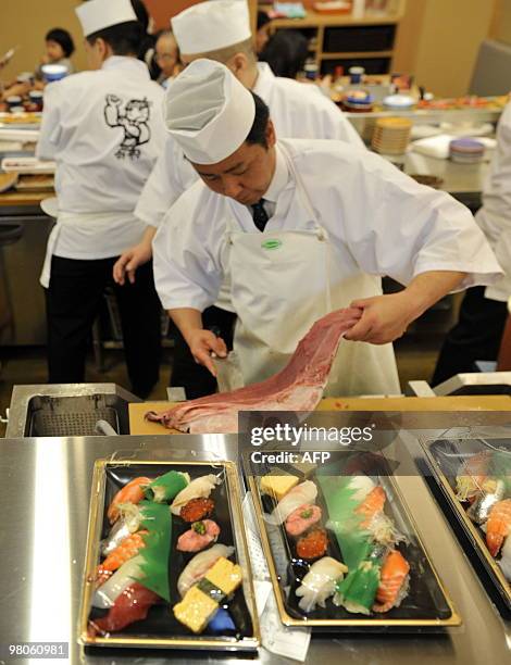 To go with story Species-CITES-UN-Japan-tuna-farm In a picture taken on March 12, 2010 a sushi chef cuts up bluefin tuna at a sushi restaurant in...