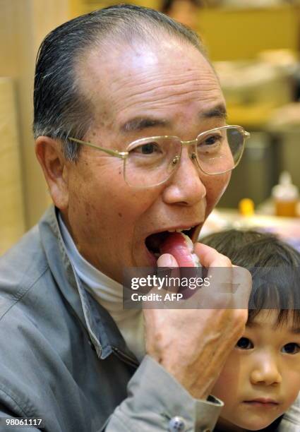 To go with story Species-CITES-UN-Japan-tuna-farm In a picture taken on March 12, 2010 a man eats bluefin tuna sushi at a sushi restaurant in...