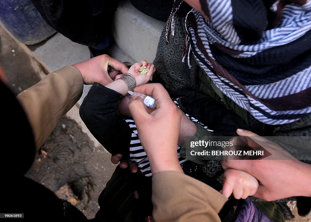 An Afghan child holding sweets in her ha