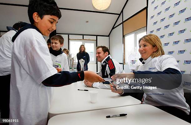 Andrew Strauss and Charlotte Edwards sign autographs during the NatWest CricketForce at Harrow Saint Mary's Cricket Club on March 26, 2010 in London,...