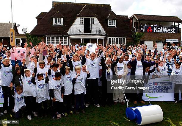 Andrew Strauss together with Charlotte Edwards and volunteers pose for photographs during the NatWest CricketForce at Harrow Saint Mary's Cricket...