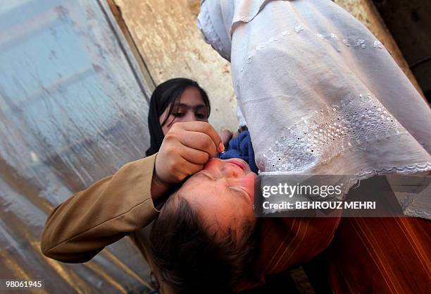 An Afghan child cries as a health worker administers the polio vaccine on the second day of a vaccination campaign in Kabul on March 15, 2010. A...