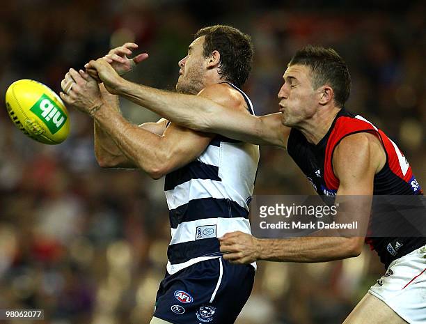 Cameron Mooney of the Cats competes with Cale Hooker of the Bombers during the round one AFL match between the Geelong Cats and the Essendon Bombers...
