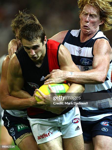 Jobe Watson of the Bombers is tackled by Cameron Ling of the Cats during the round one AFL match between the Geelong Cats and the Essendon Bombers at...