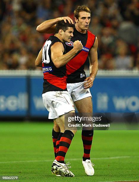 Ben Howlett of the Bombers celebrates a goal with his captain Jobe Watson during the round one AFL match between the Geelong Cats and the Essendon...