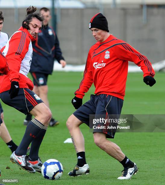 Sotirios Kyrgiakos moves in on Fernando Torres of Liverpool during a training session at Melwood training ground on March 26, 2010 in Liverpool,...