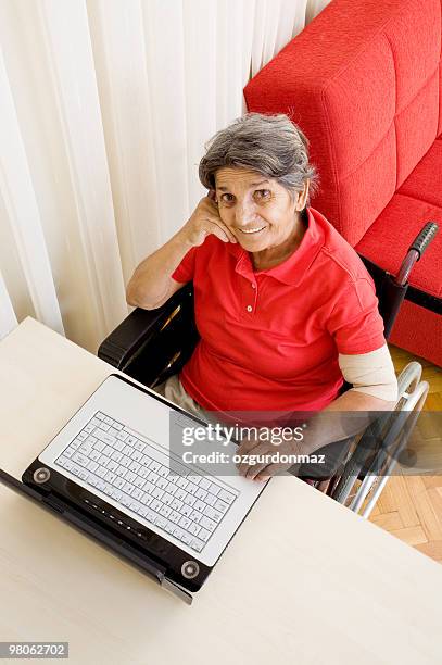 senior woman using laptop - ozgurdonmaz stock pictures, royalty-free photos & images